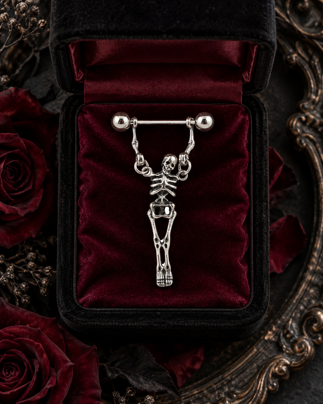 Skeleton dangle nipple ring on black velvet