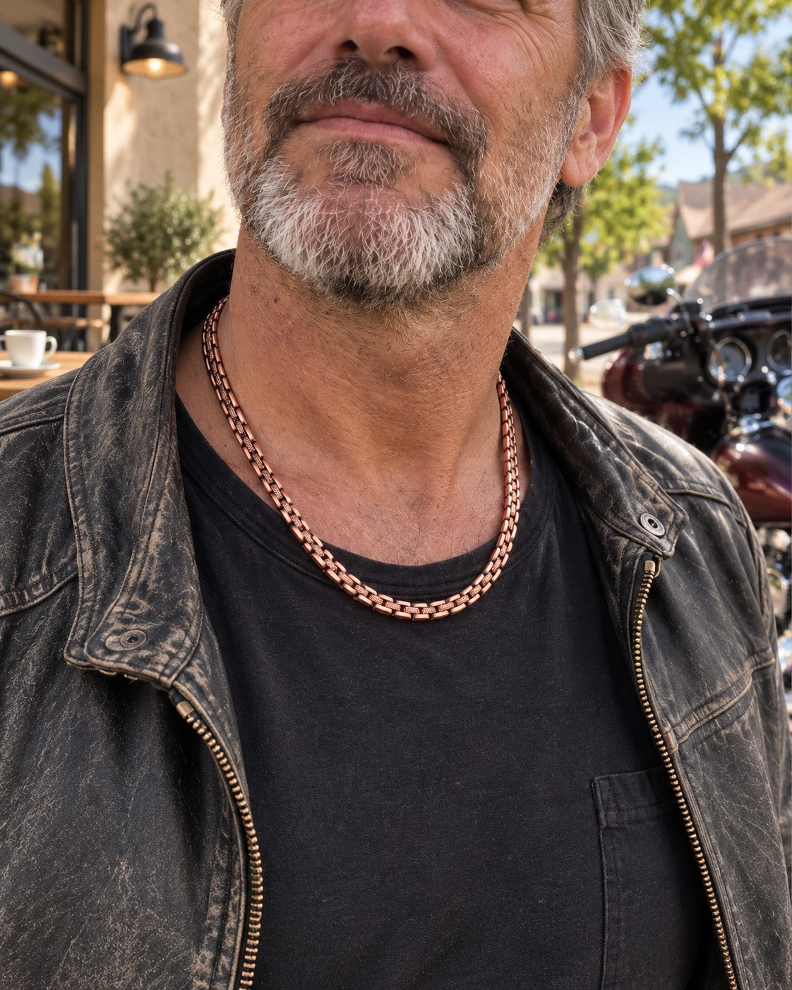 Man wearing the copper chain with a dark shirt and denim