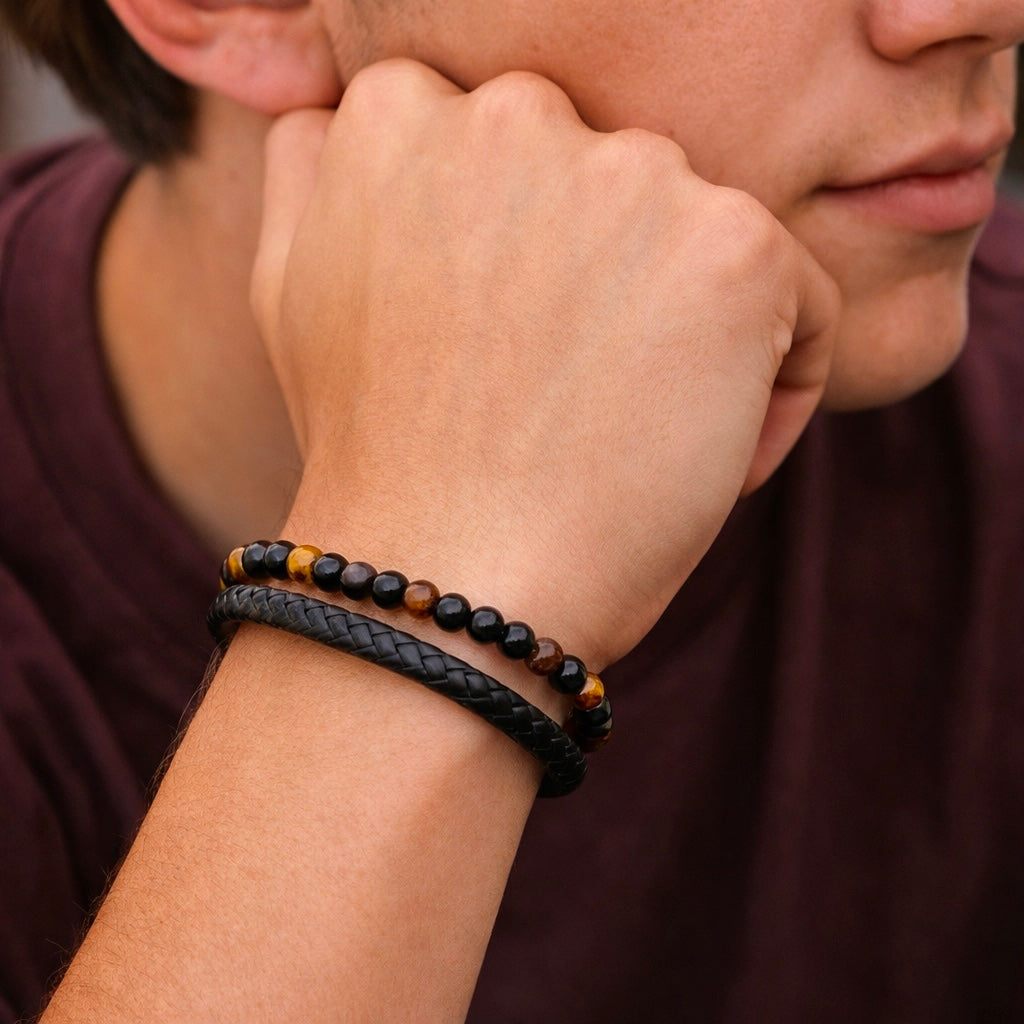 Young man wearing the tiger eye and black braided bracelet with a casual shirt