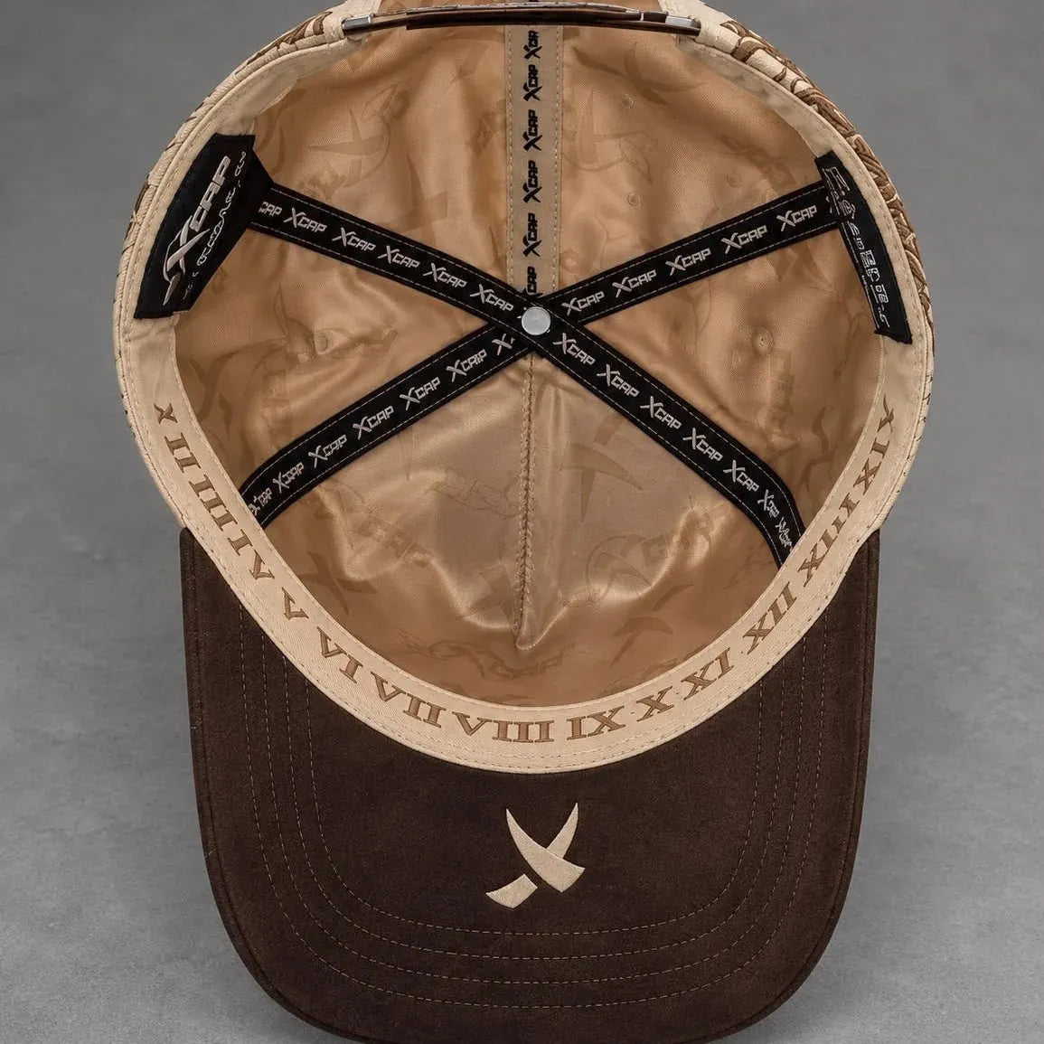 Inside view of the Viacrucis cap with artwork and Roman numeral band