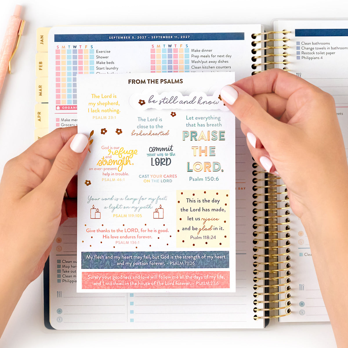 2027 navy plaid home planner with sticker page being held