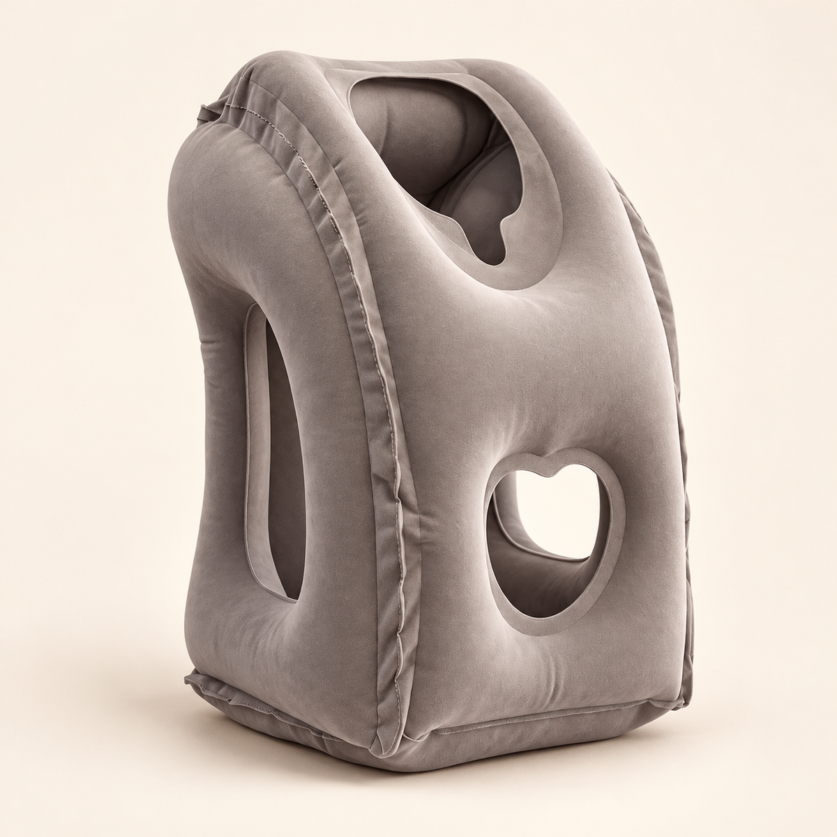 Studio view of an unbranded gray inflatable travel sleep pillow