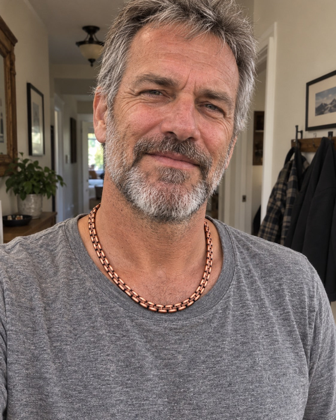 Casual illustrative phone-style photo of the copper chain worn with an everyday shirt